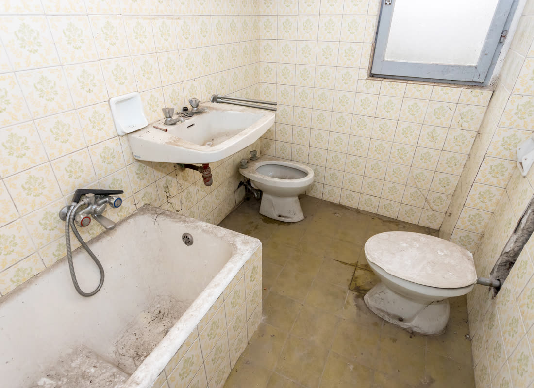 An original bathroom with dated tiling and fittings