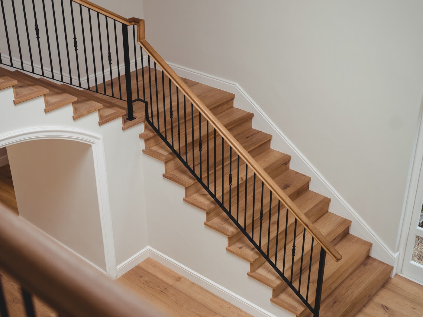 A hallway and staircase finished in wood flooring