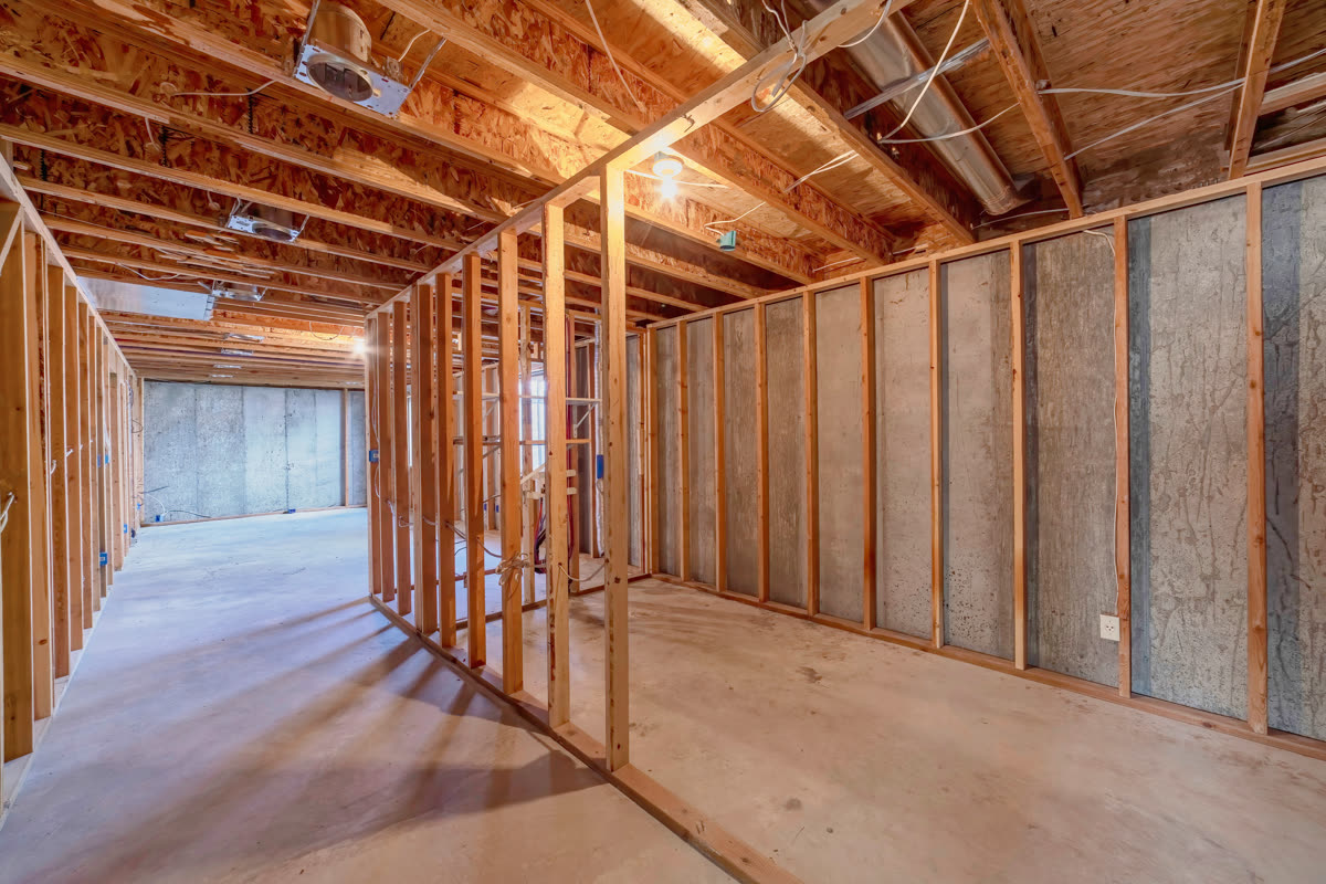 Stud framing and services exposed in a room under construction