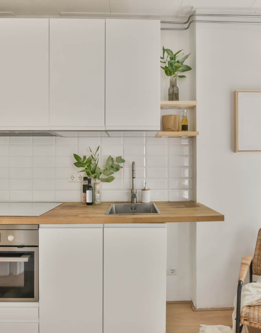 A finished kitchen with island seating and pendant lighting