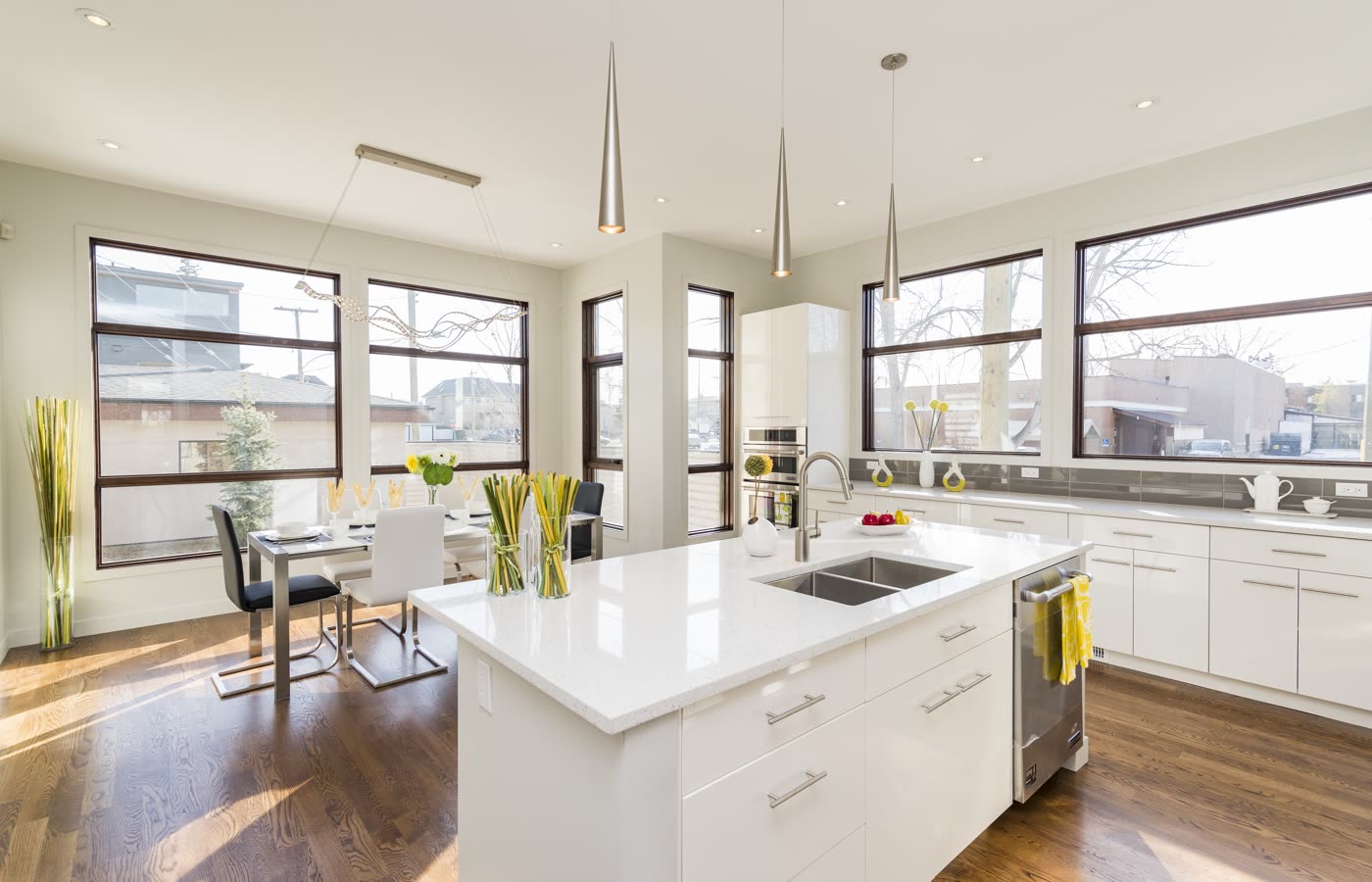 A renovated kitchen with large windows and full cabinetry