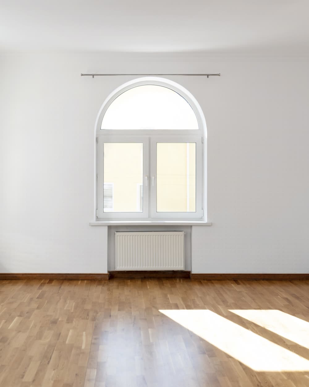 A room repainted in a warm off-white with white trim